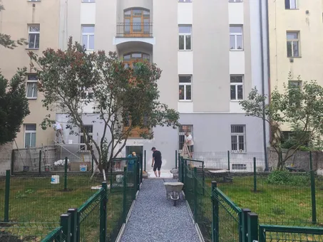 Probíhající rekonstrukce fasády bytového domu Pod Pekárnami, pohled na dvorní průčelí